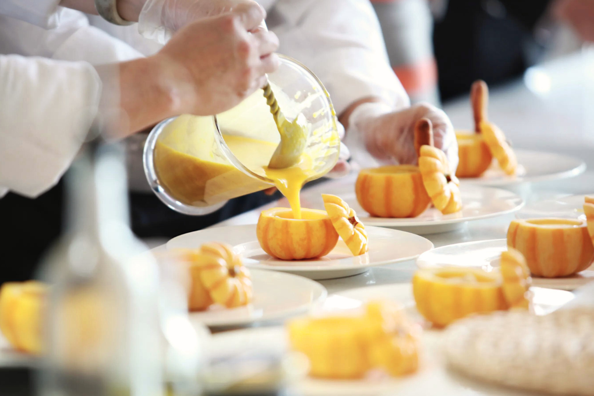 caterers filling containers with pudding