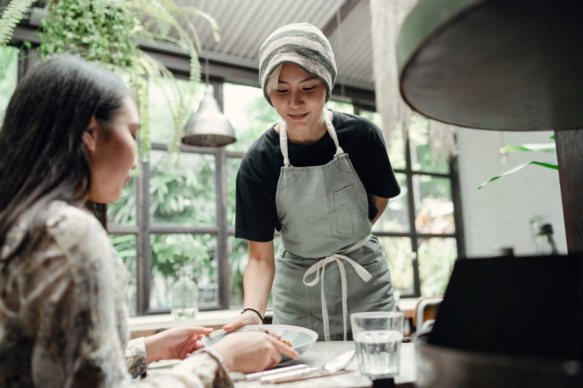 waitress serving food in a cafe