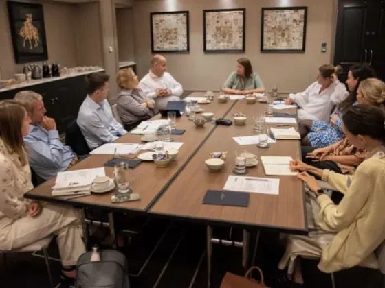 group of people sat around a conference table