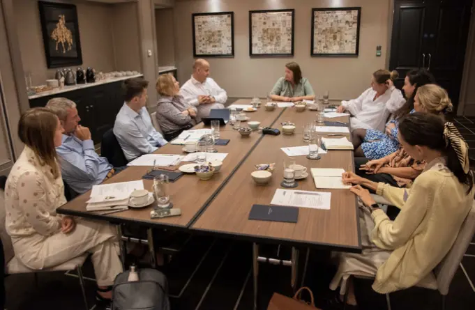 group of people sat around a conference table