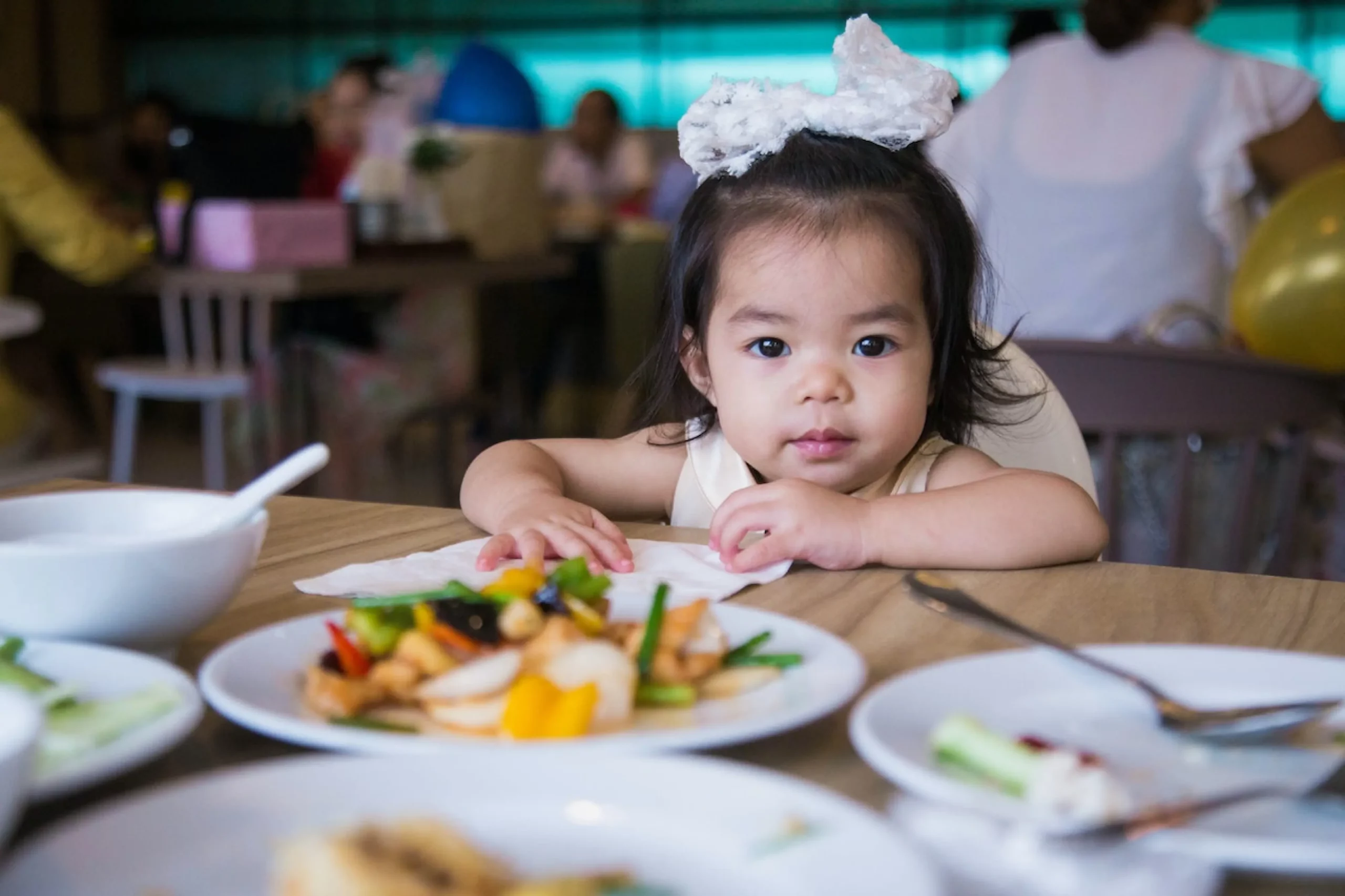 image of a child eating a meal in a restaurant