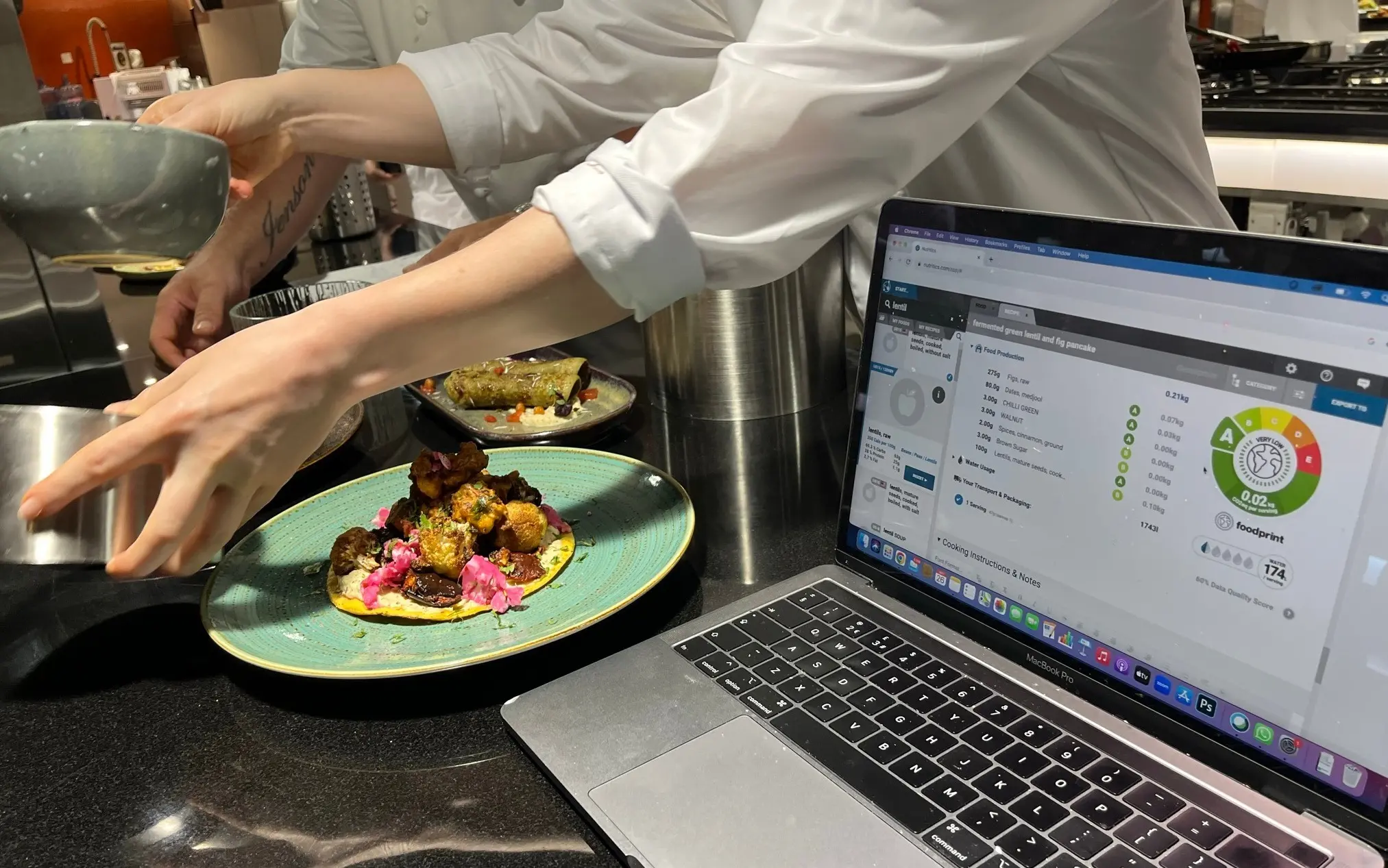 image of nutritics open on a laptop next to chefs working