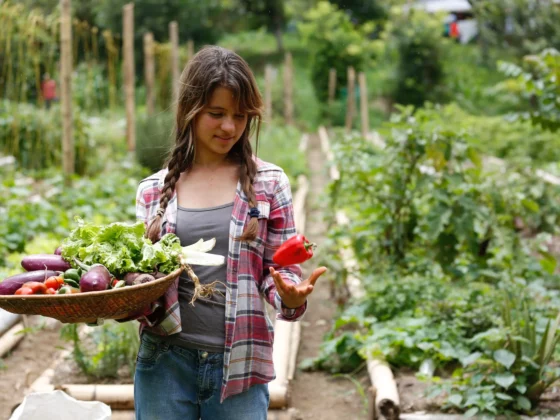 photo of woman examining pepper on a farm