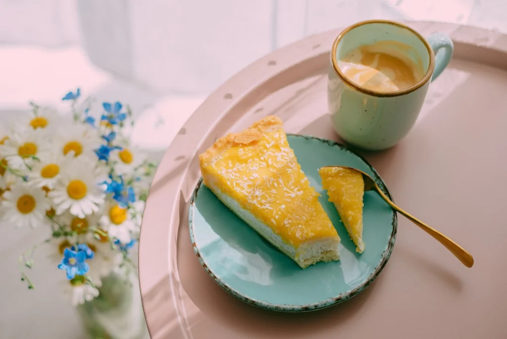 image of a portion of cake with a hot cup of coffee