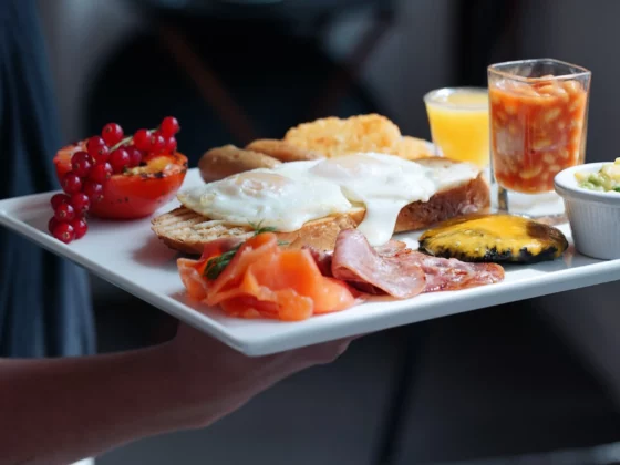 cooked English breakfast with fruit juices