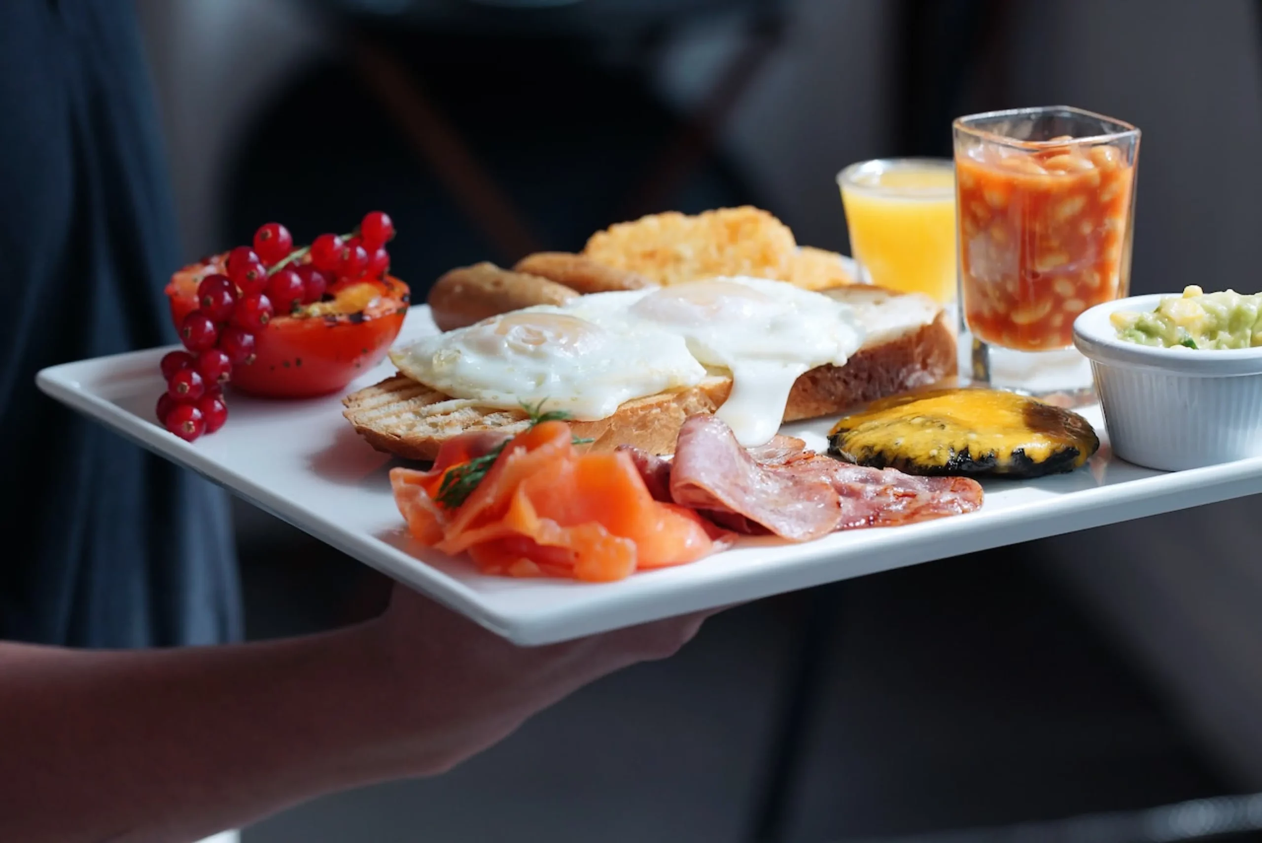 cooked English breakfast with fruit juices