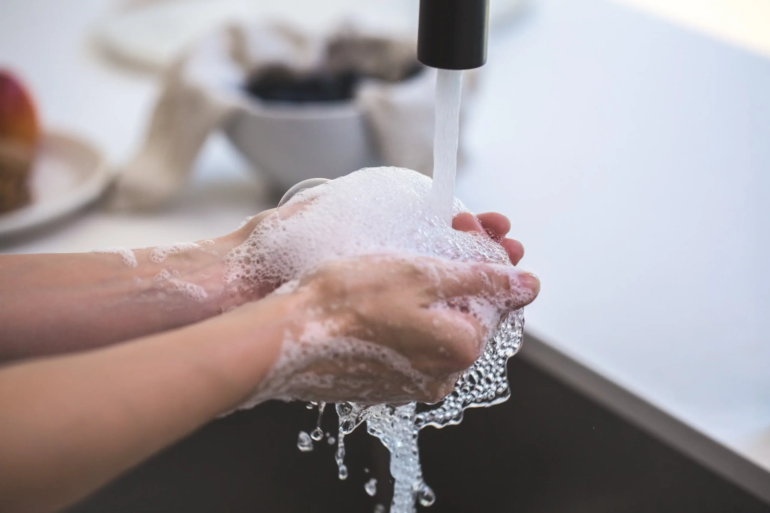 photo of someone washing their hands with suds
