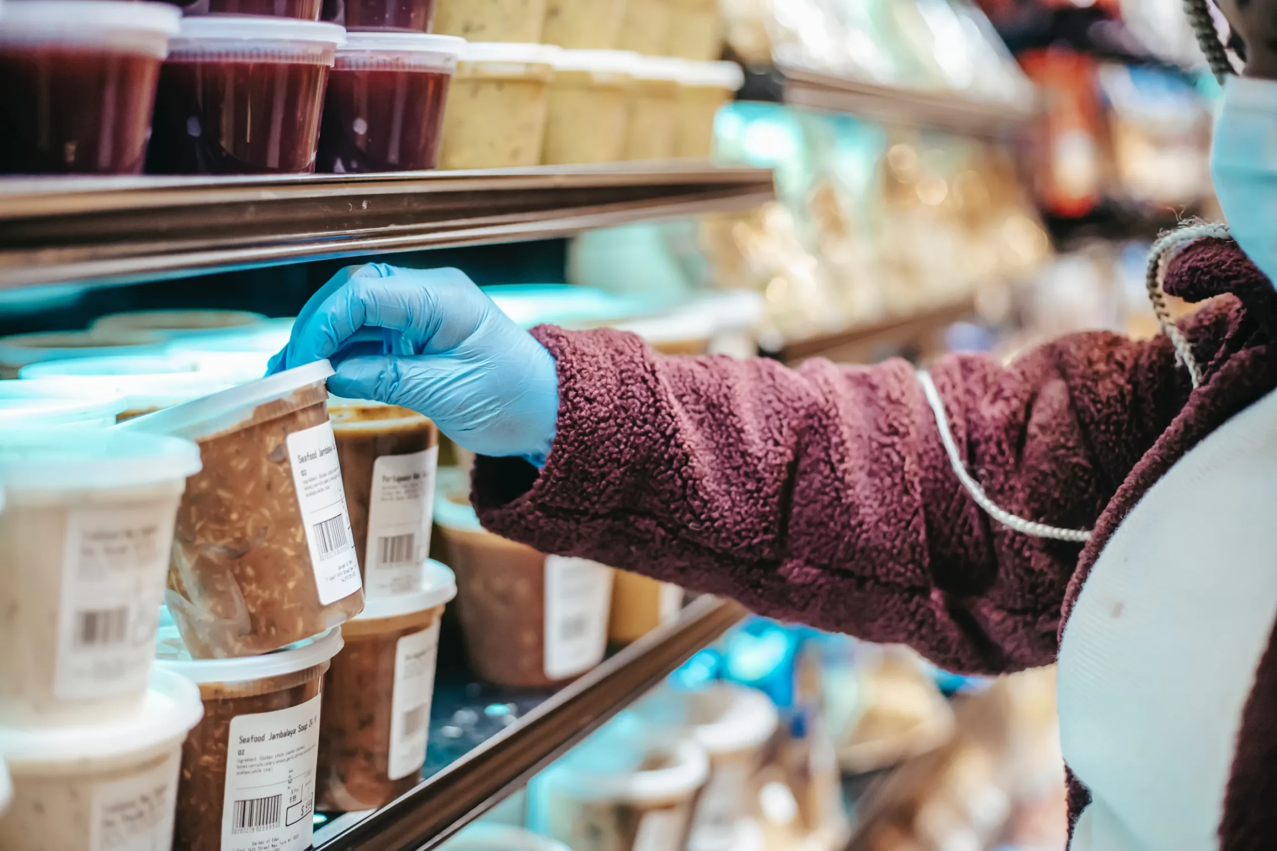 woman taking item from shelf