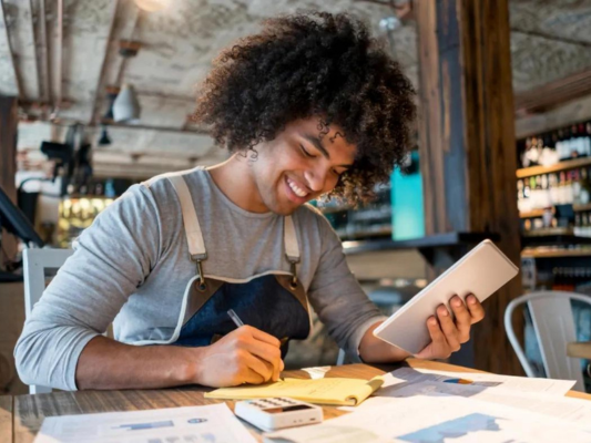 Staff member doing accounts in restaurant