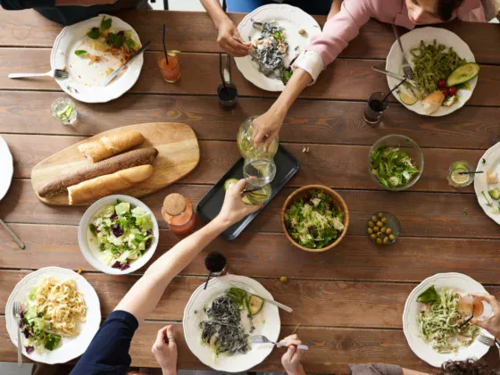 photo from above of people eating food at a large table