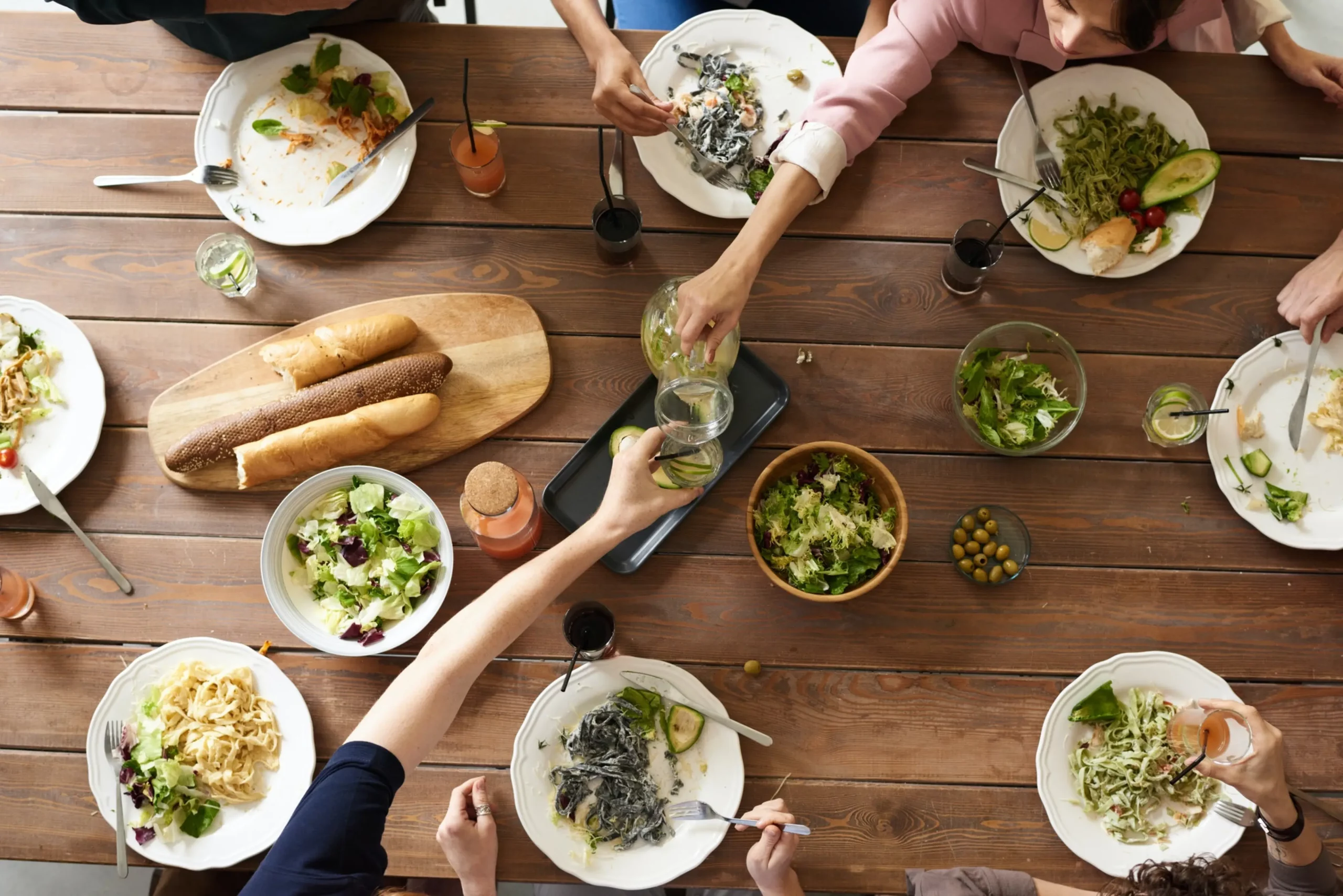 photo from above of people eating food at a large table