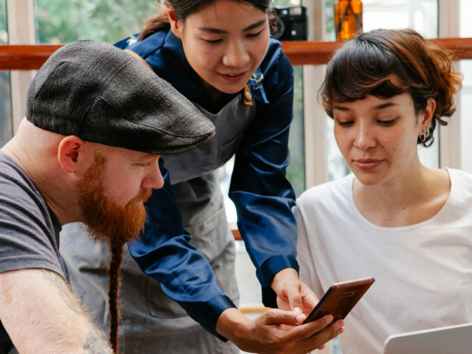 Waitress helping customers with the menu