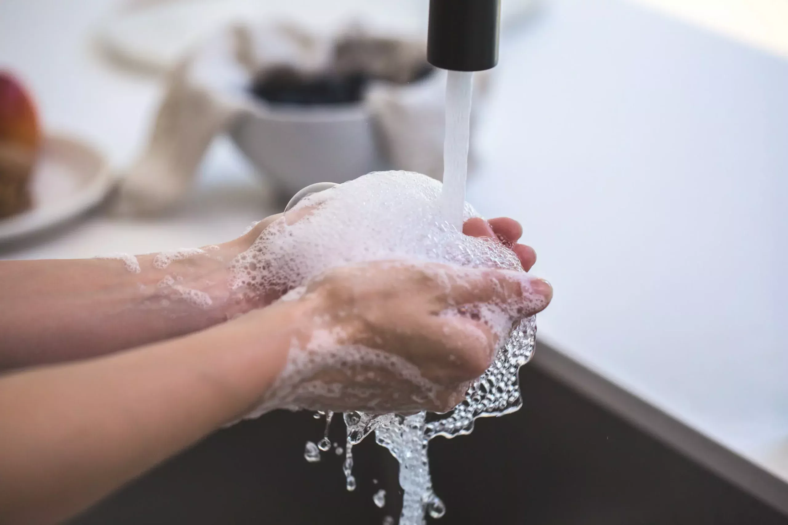 photo of someone washing their hands with suds