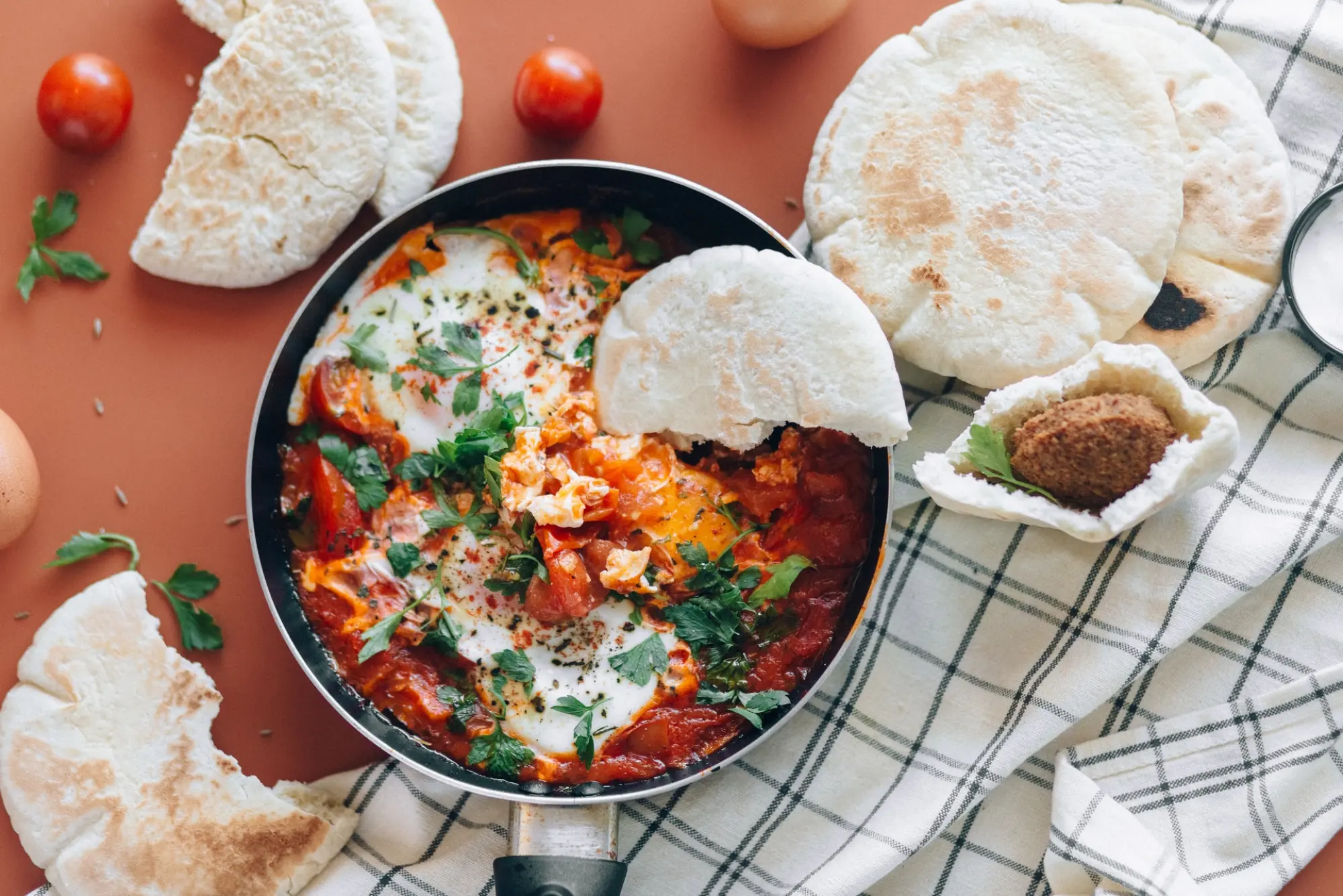 shakshuka in a pan with naan bread