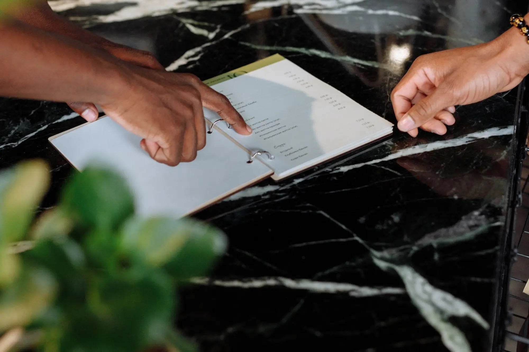 person pointing at item on menu