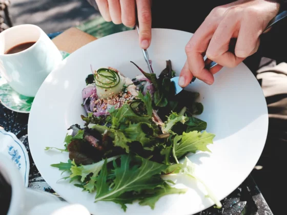 close up of someone eating a salad