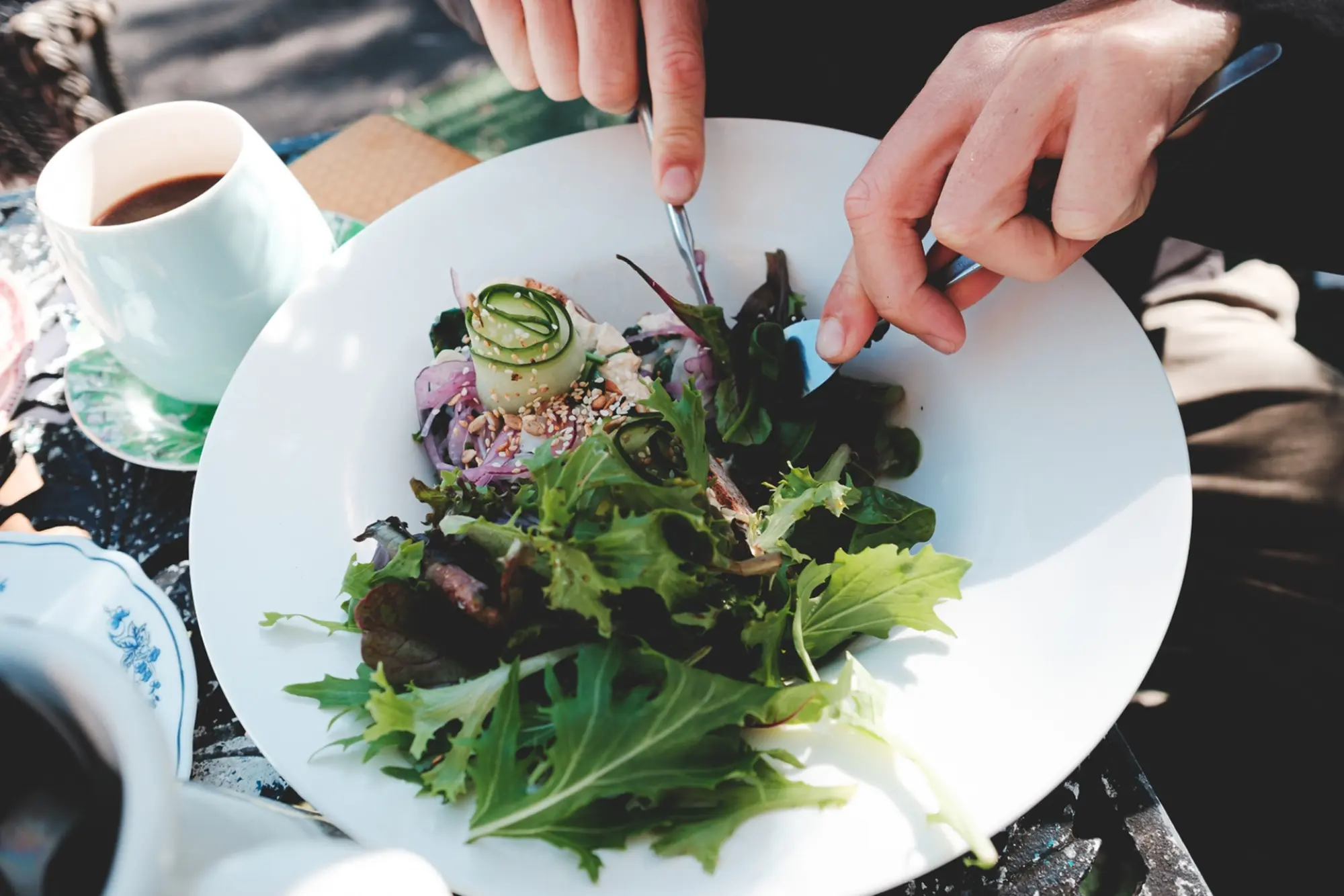 close up of someone eating a salad