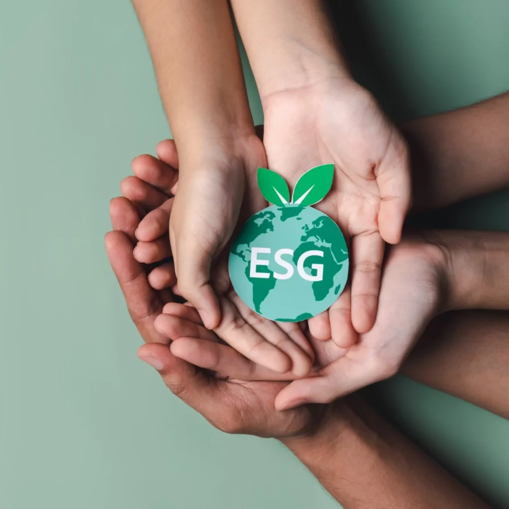 image of hands holding the words ESG shaped like the earth