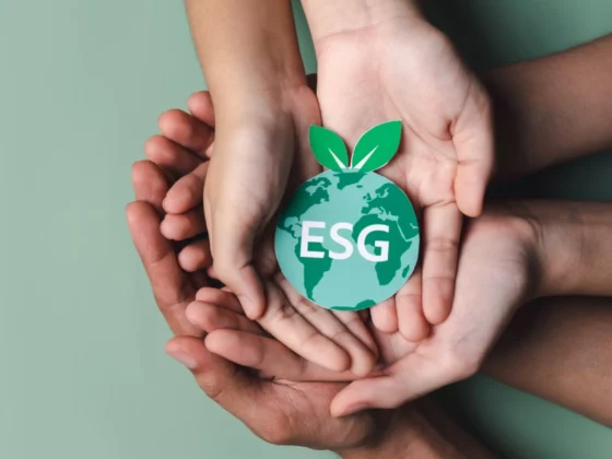 image of hands holding the words ESG shaped like the earth