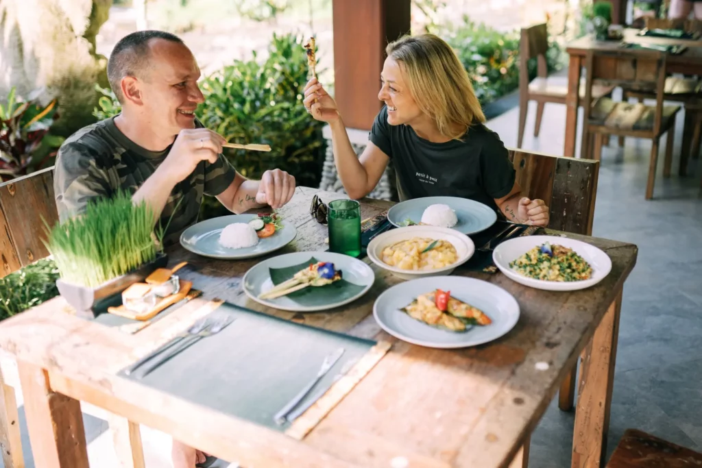 two people eating food in a restaurant