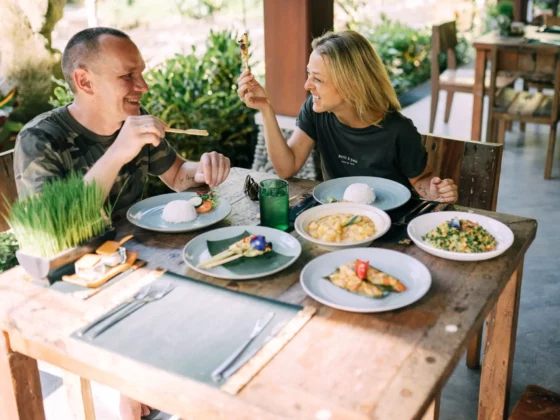 two people eating food in a restaurant