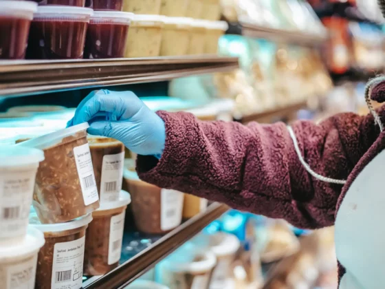 person holding tub with food label on the front