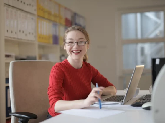 woman smiling while at desk