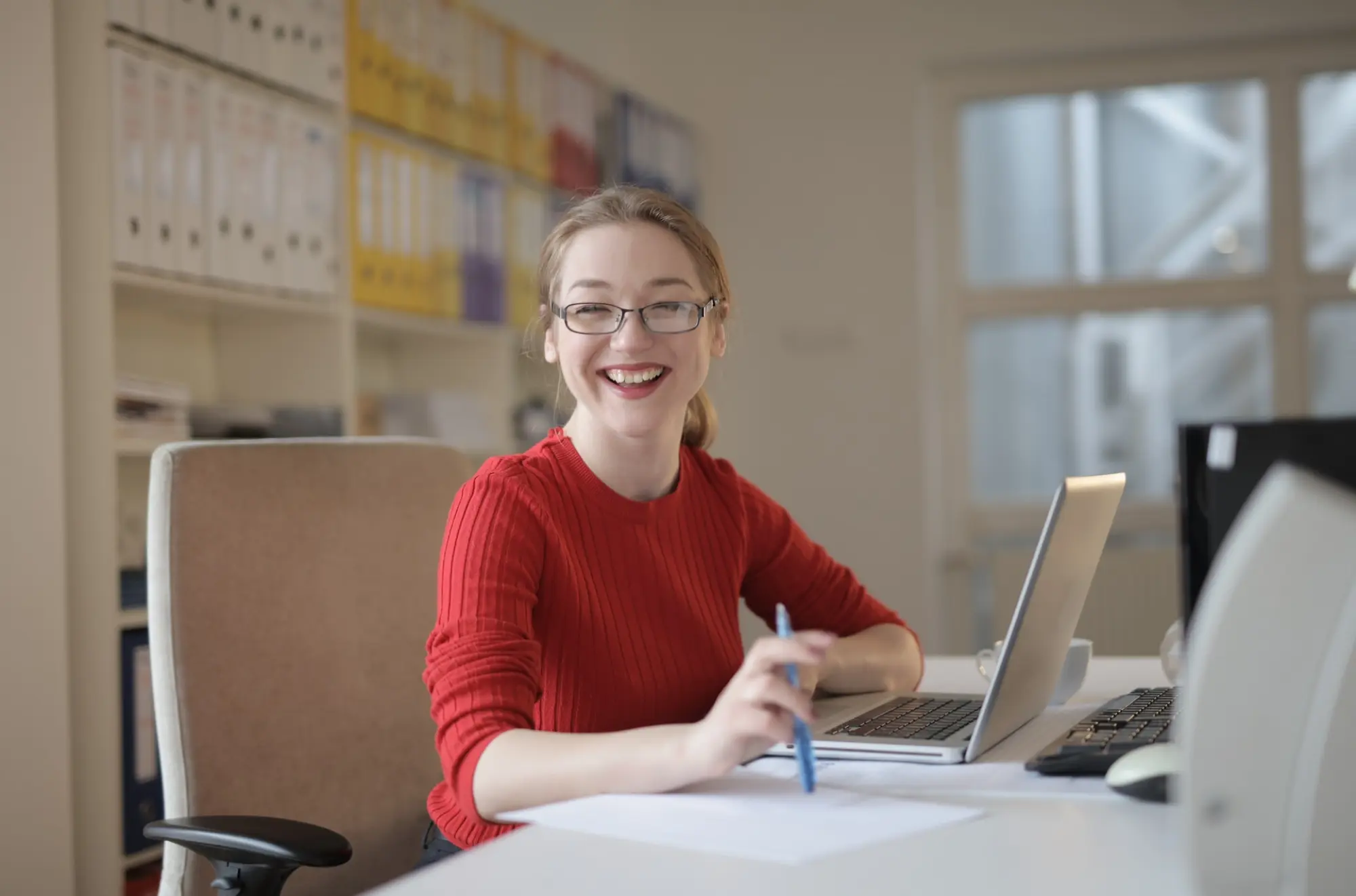 woman smiling while at desk