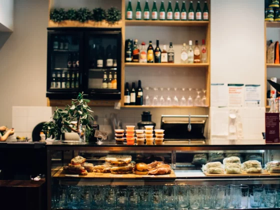 restaurant counter top with food arranged behind