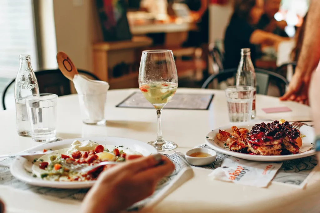 people eating a meal with wine