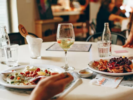 people eating a meal with wine