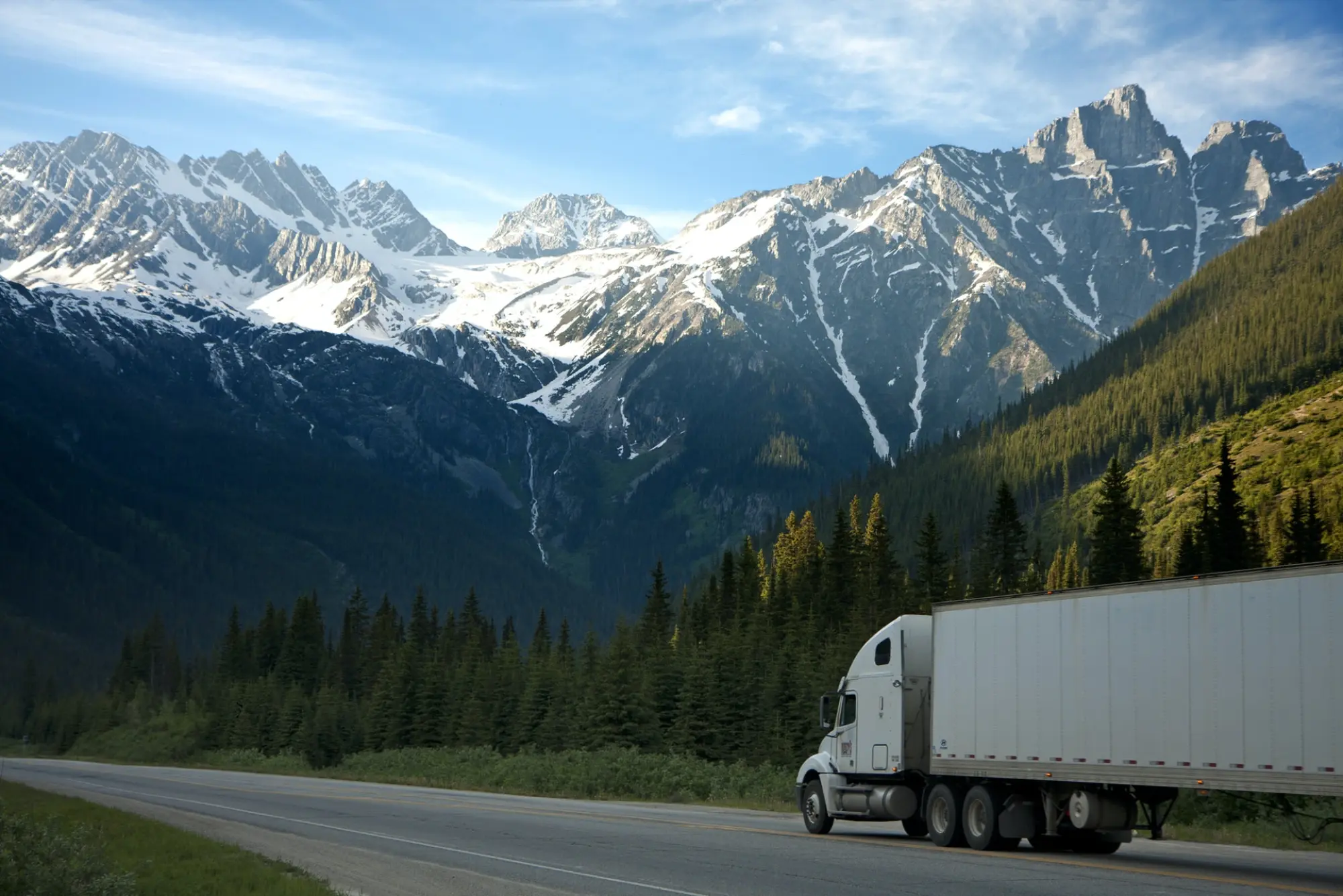 truck driving with mountains in the background