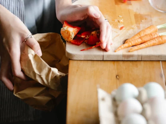 close up of woman putting food waste in bin