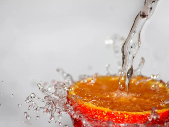 water hitting an orange