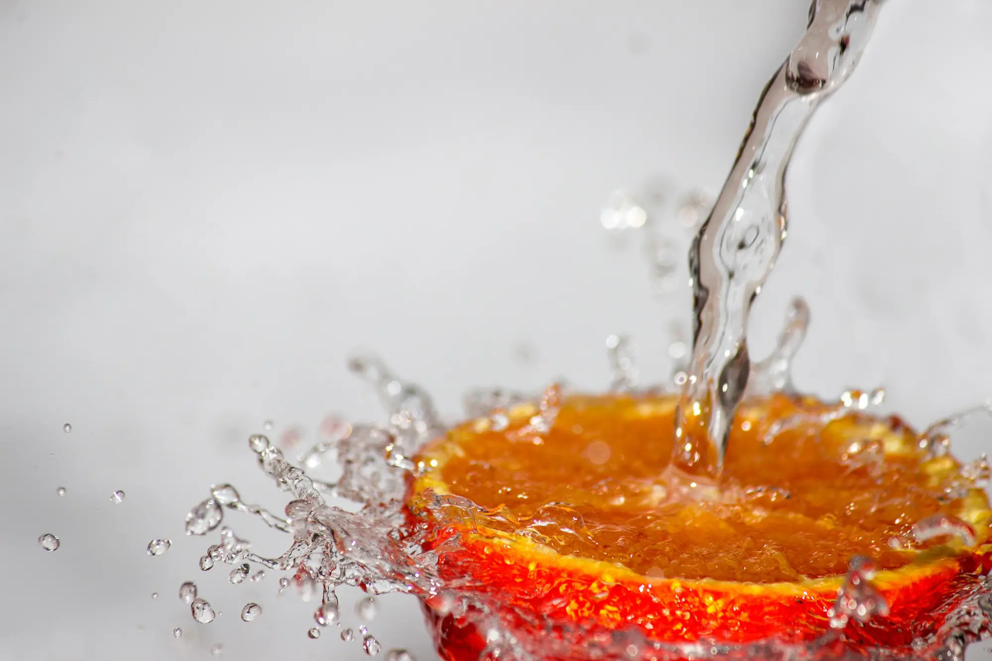 water hitting an orange